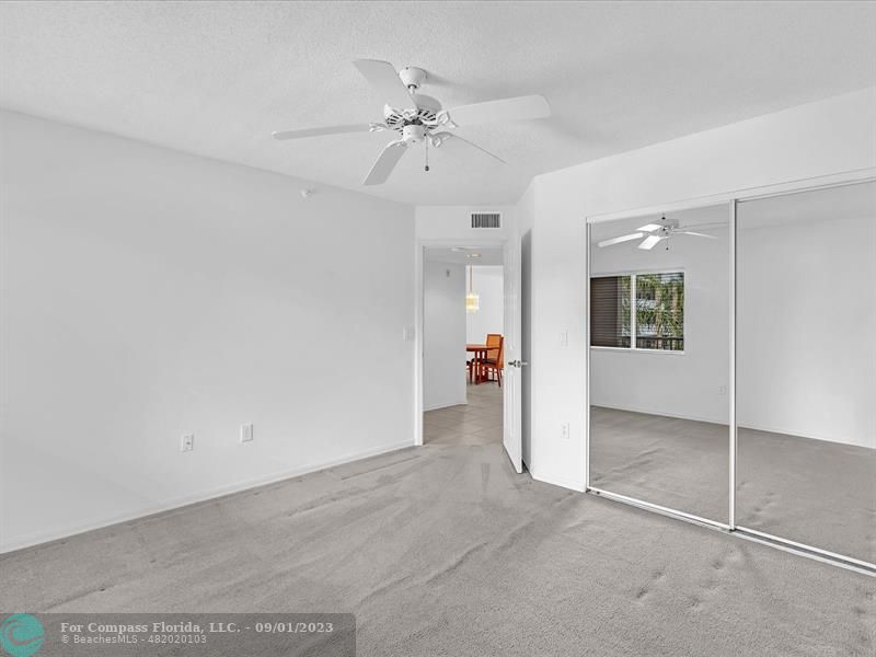 9551 Weldon Circle, Unit E311 Tamarac, FL 33321 - Photo 30 of 64 an empty room with a chandelier fan and windows