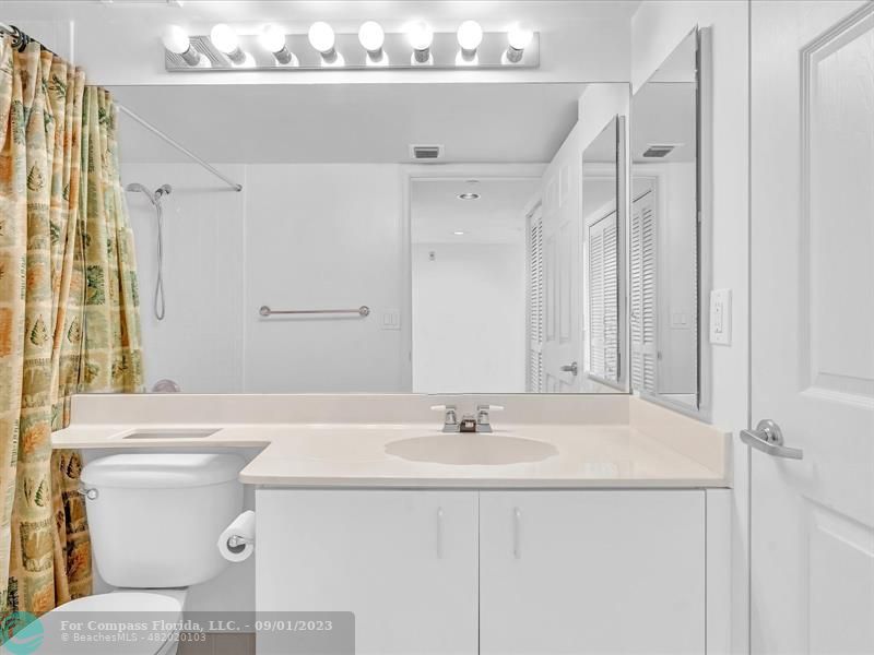 9551 Weldon Circle, Unit E311 Tamarac, FL 33321 - Photo 32 of 64 a bathroom with a sink a toilet and a mirror
