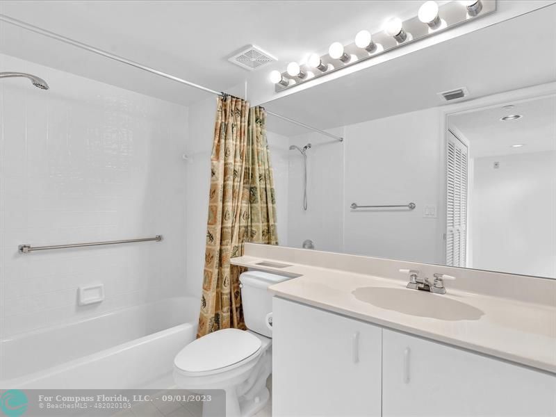 9551 Weldon Circle, Unit E311 Tamarac, FL 33321 - Photo 33 of 64 a bathroom with a sink a toilet a mirror and shower