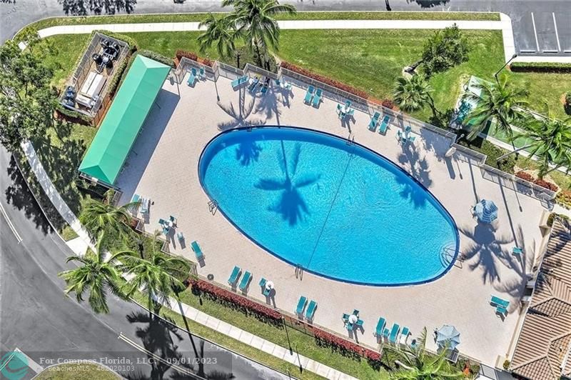 9551 Weldon Circle, Unit E311 Tamarac, FL 33321 - Photo 41 of 64 a view of swimming pool with a potted plant and a floor to ceiling window