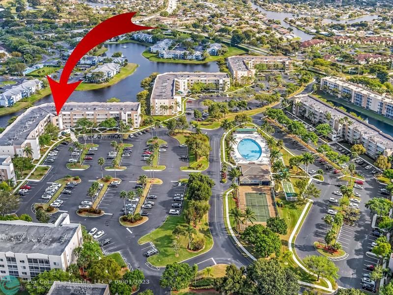 9551 Weldon Circle, Unit E311 Tamarac, FL 33321 - Photo 44 of 64 an aerial view of residential building and parking space