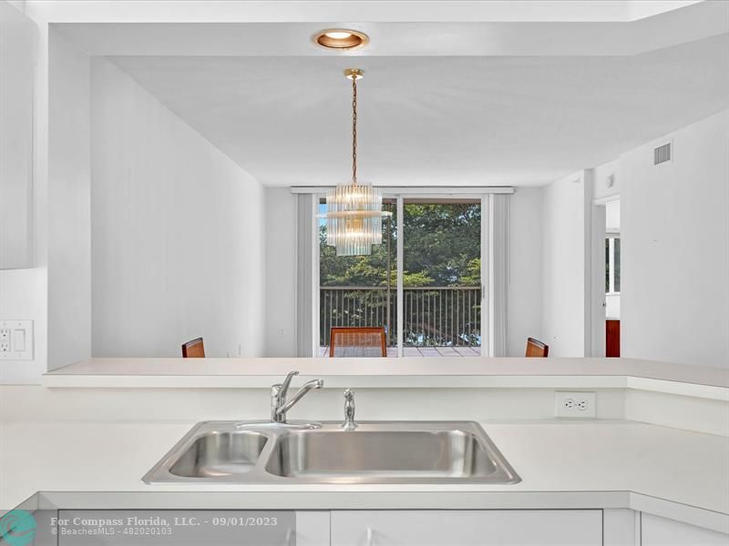 9551 Weldon Circle, Unit E311 Tamarac, FL 33321 - Photo 8 of 64 a view of a sink a window and couch