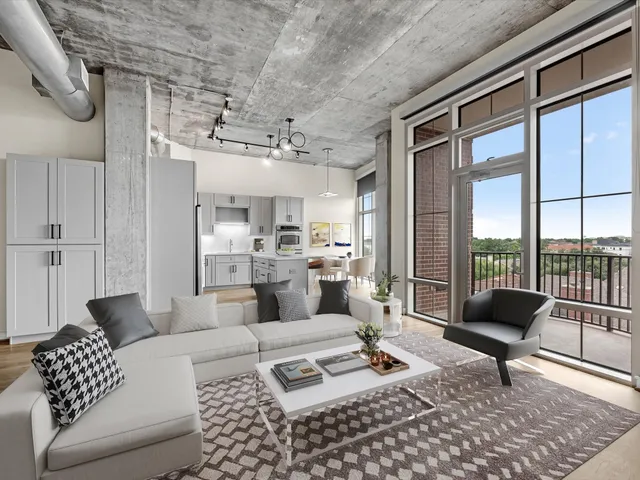 a living room with furniture and a floor to ceiling window