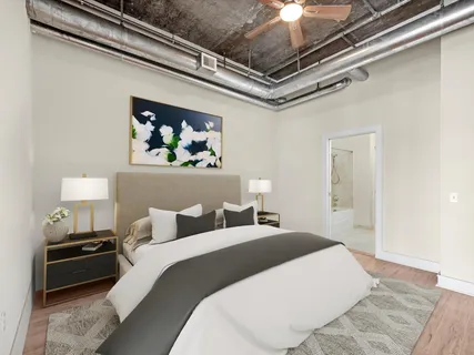 a bedroom with a bed and a painting on the wall