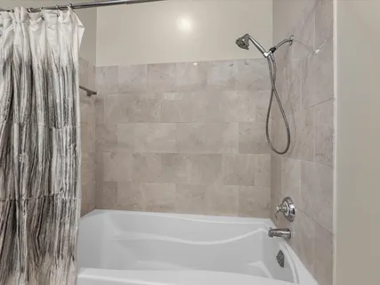 a bathroom with a bath tub and a shower