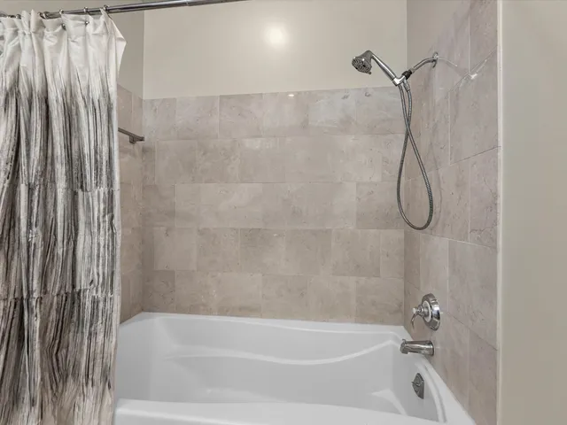 a bathroom with a bath tub and a shower