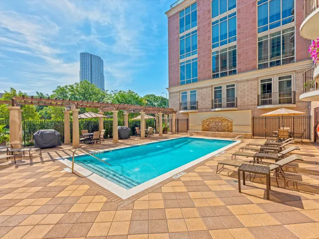a view of a patio with a dining table and chairs with wooden floor and fence
