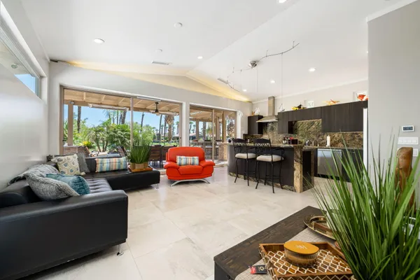 a living room with furniture fireplace and a large window