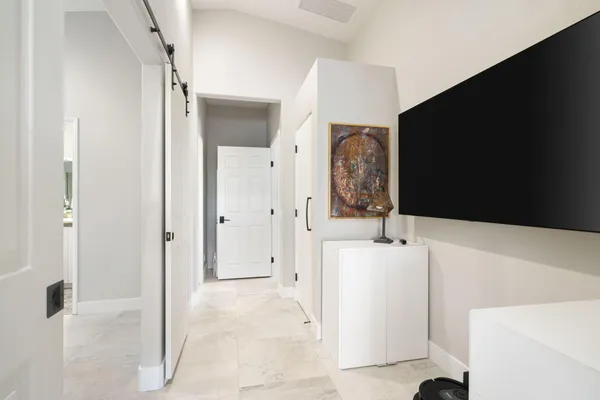 a spacious bedroom with a bed and a cabinets