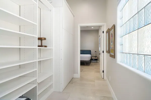 a view of a patio with a table and chairs and potted plants
