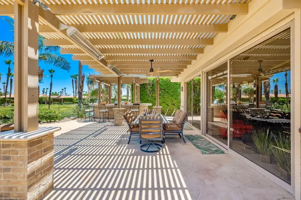 a view of a patio with couches chairs and a potted plant