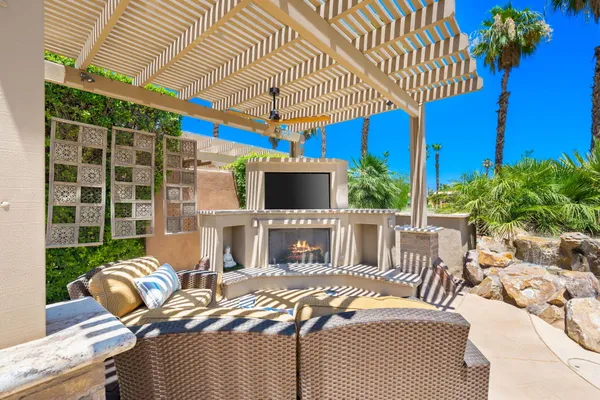 a view of a patio with couches chairs and a potted plant