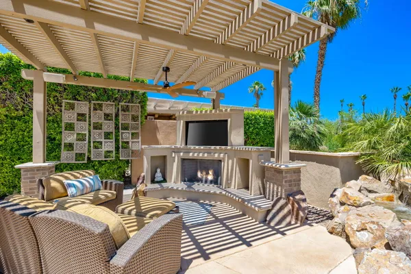 a view of a backyard with plants and outdoor seating