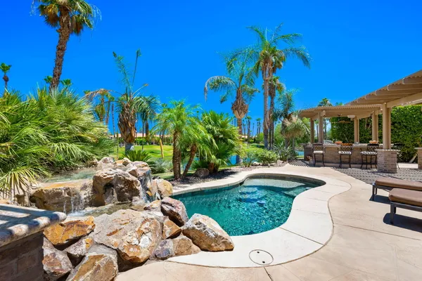 a view of a backyard with sitting area