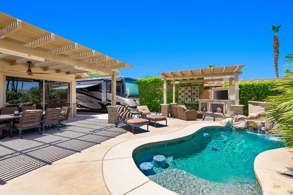 a view of a patio with a dining table and chairs with wooden floor