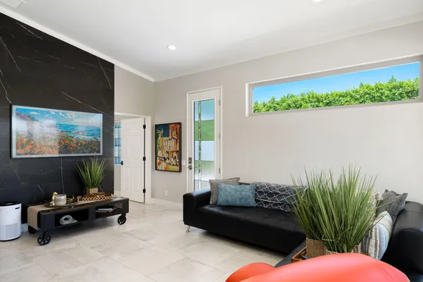 a living room with furniture and a potted plant
