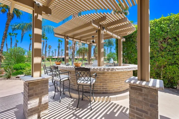 a view of balcony with furniture and garden