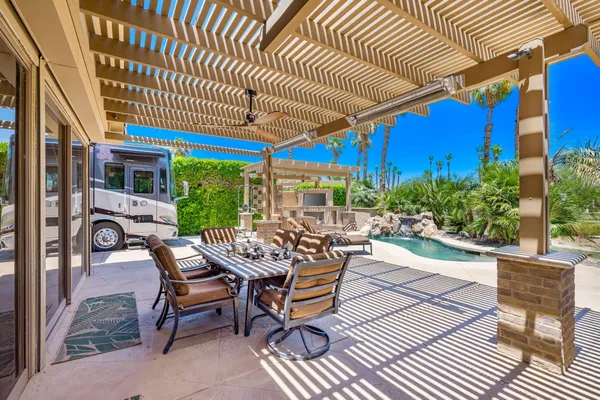a view of a patio with table and chairs and potted plants