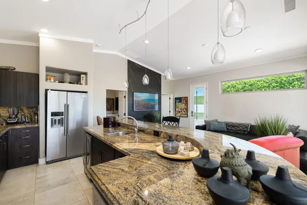 a kitchen with granite countertop a sink stove and refrigerator
