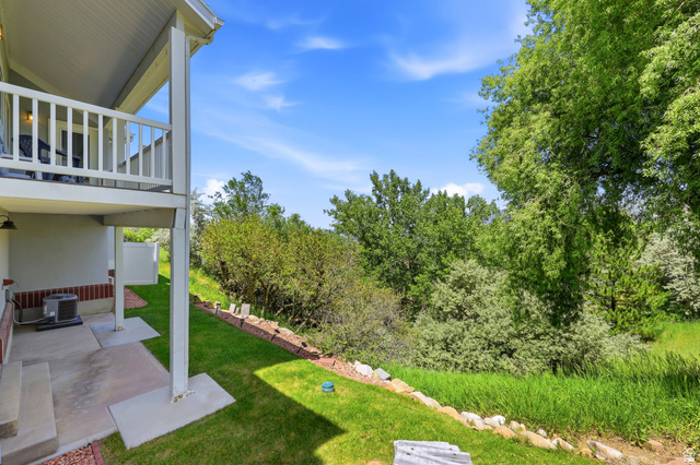 3766 Cardiff Circle Bountiful, UT 84010 - Photo 19 of 46 Tiered outdoor space with a concrete patio and overhead balcony featuring white railings
