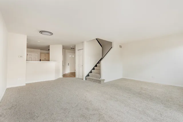 a view of an empty room with a staircase