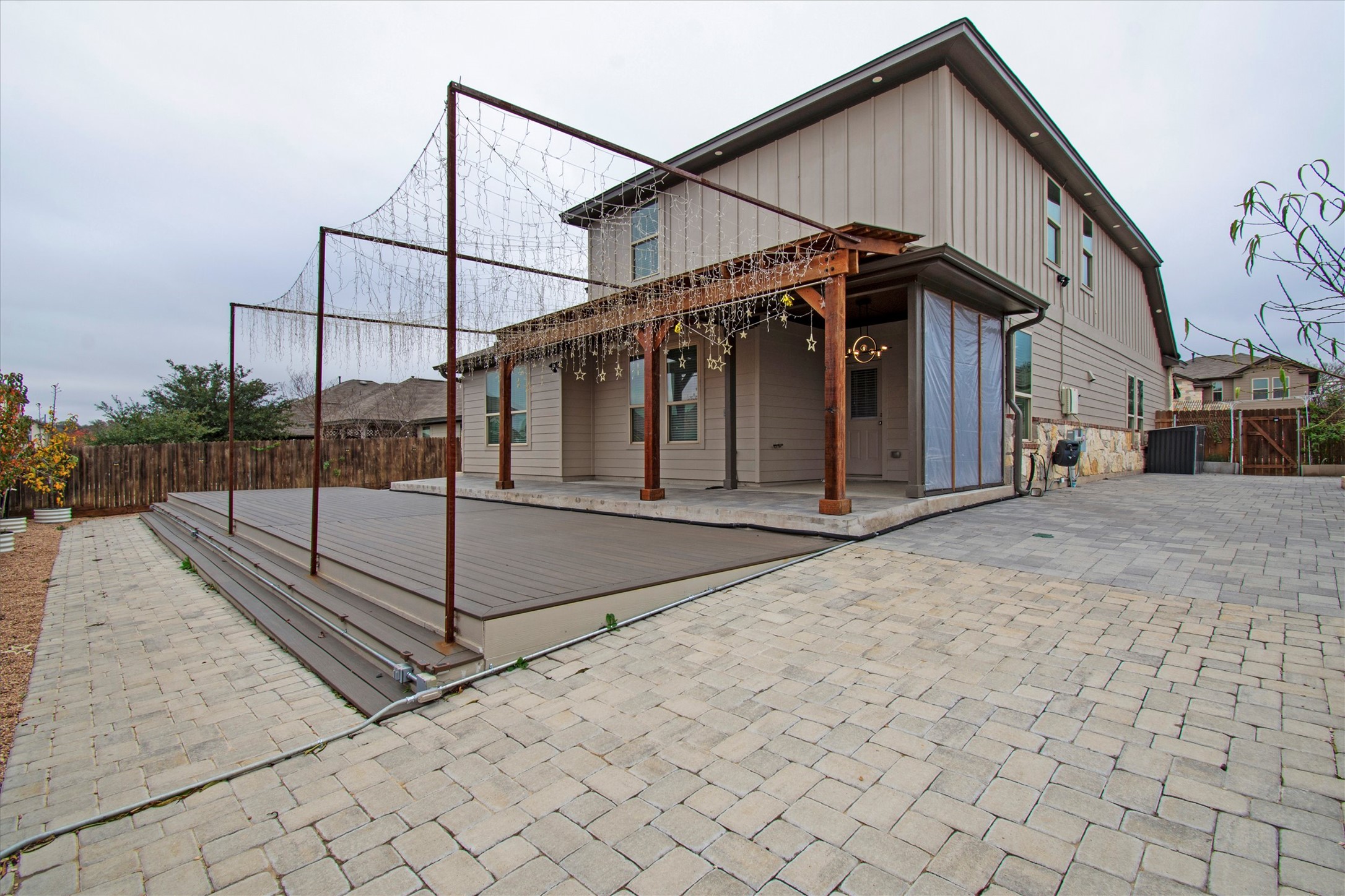 13601 Larrys Lane Manchaca, TX 78652 - Photo 21 of 40 Rear view of house with a patio, a wooden deck, and a gate