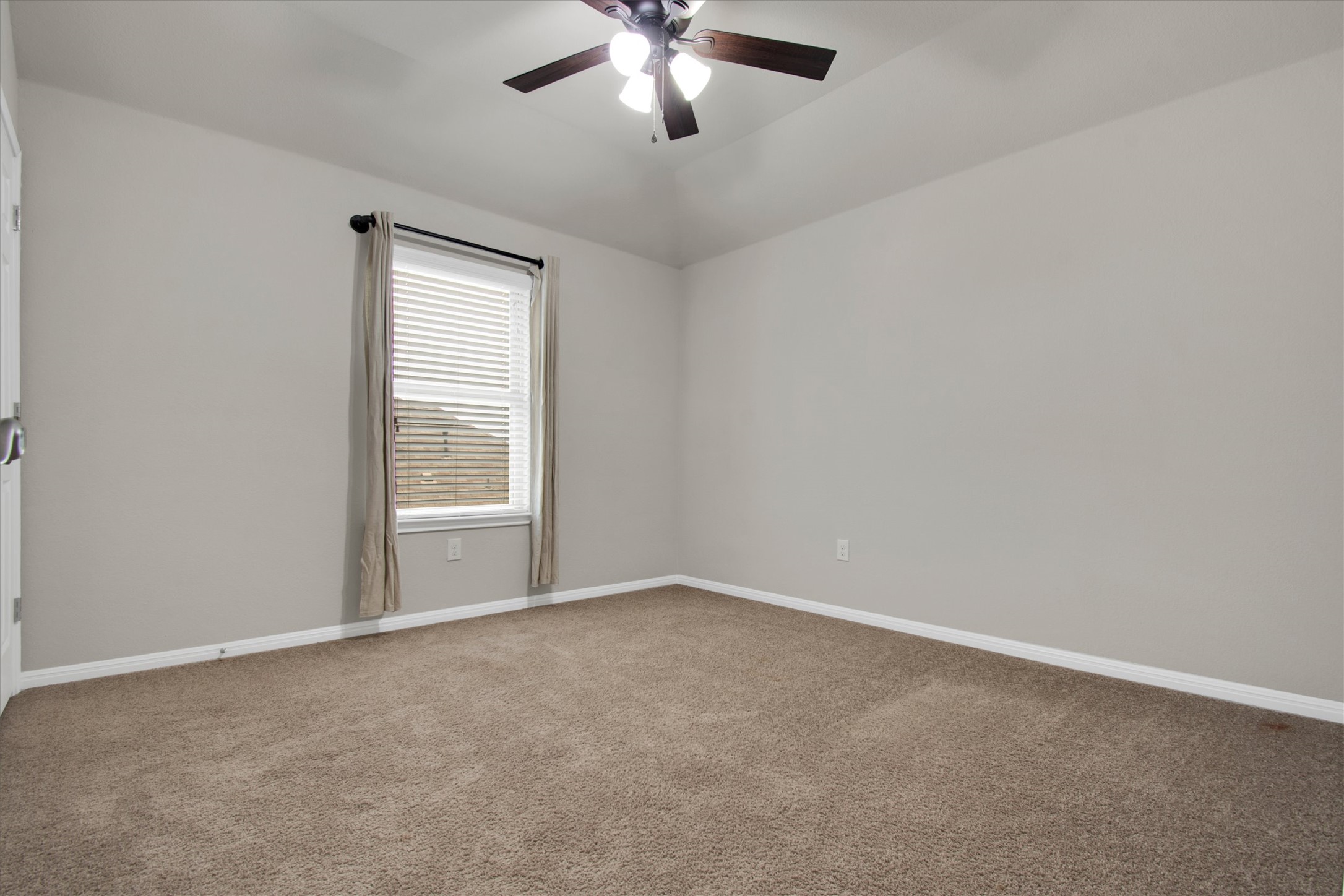 13601 Larrys Lane Manchaca, TX 78652 - Photo 34 of 40 Empty room with light carpet, a ceiling fan, and lofted ceiling