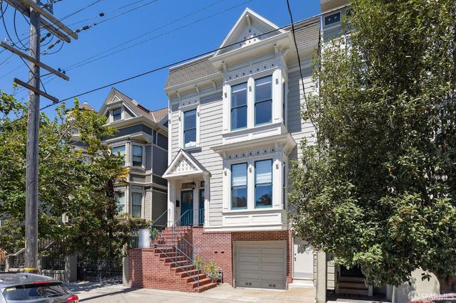 a front view of a house with trees