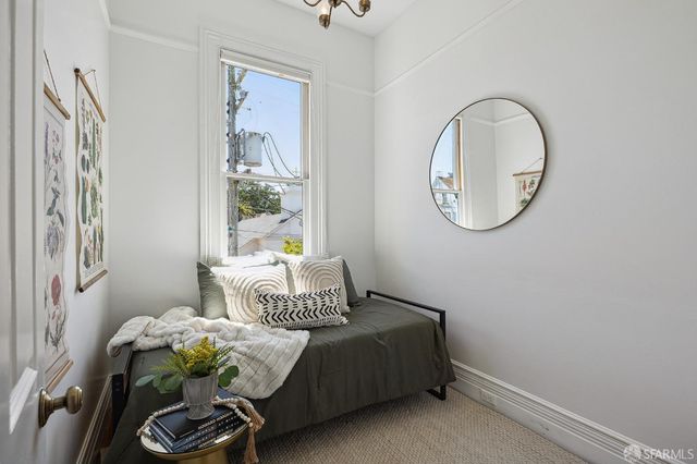 a bedroom with a bed a mirror and a window