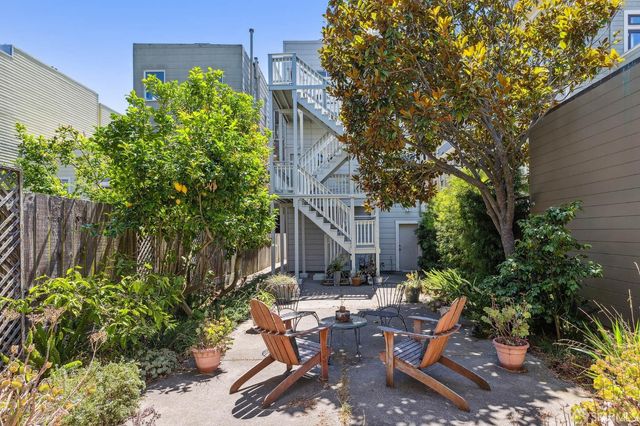 a view of backyard with outdoor seating and green space