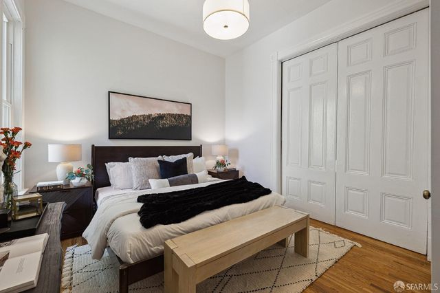 a bedroom with a bed and a painting on the wall