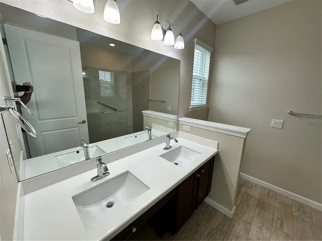 a bathroom with a sink double vanity and a mirror