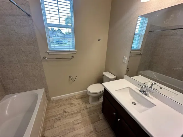 a bathroom with a sink toilet and tub