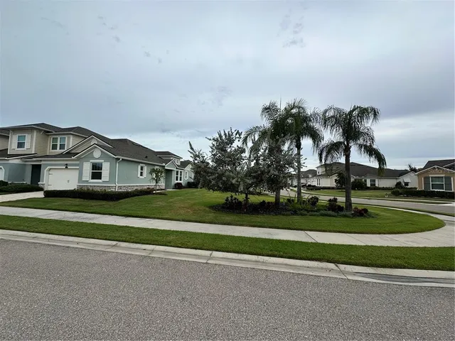 a view of houses with outdoor space and trees