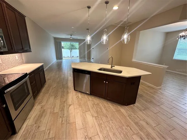 a room with wooden floors and wooden cabinets