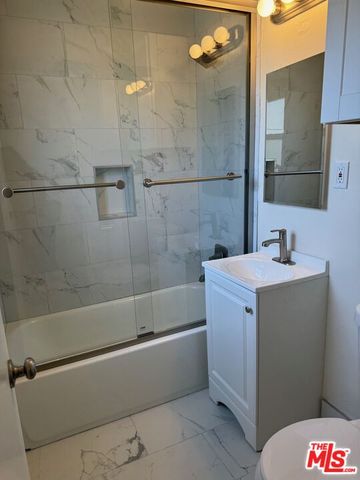 a bathroom with a bathtub and shower