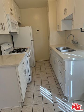 a kitchen with a sink a stove and refrigerator