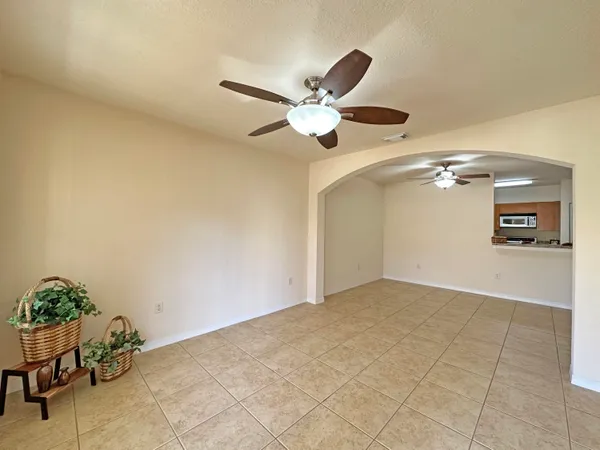 a view of a livingroom with a ceiling fan and a potted plant