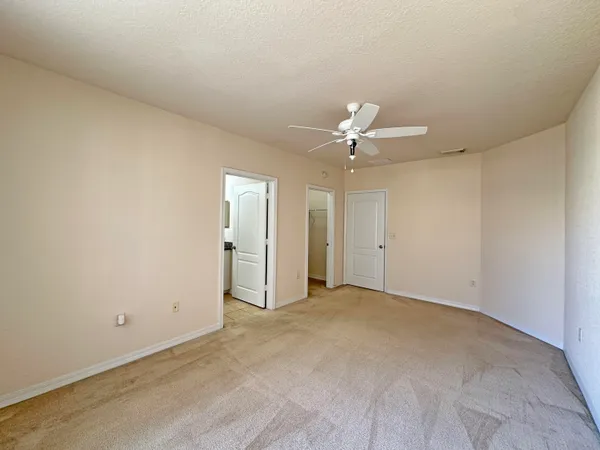 a view of an empty room with a ceiling fan