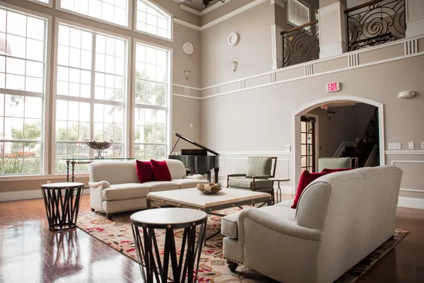 a living room with furniture and a floor to ceiling window