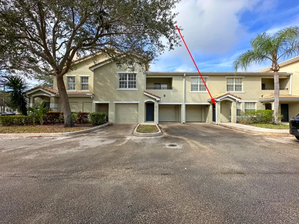 a view of a house with a yard and garage