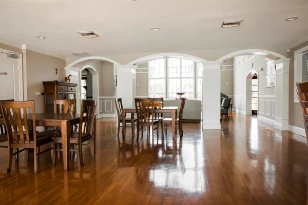 a view of a a dining room with furniture window and wooden floor