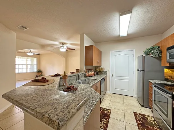 a kitchen with sink and refrigerator