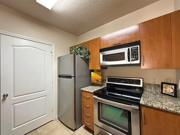 a kitchen with appliances and a refrigerator
