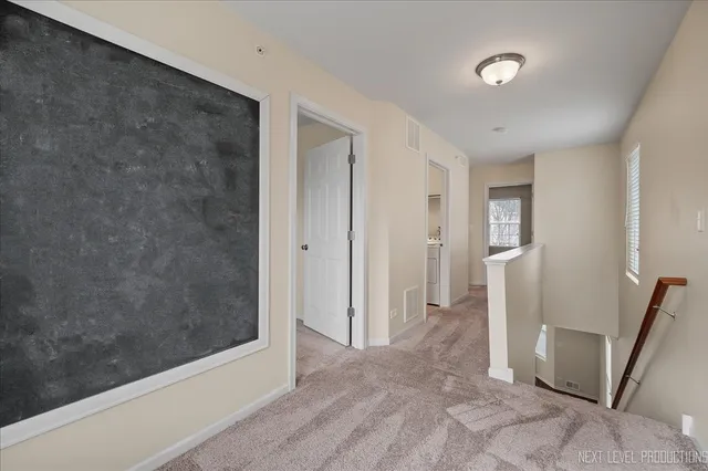 a view of a hallway with wooden shelves