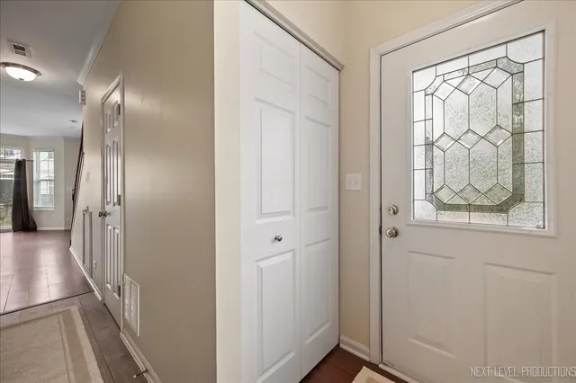 a view of hallway with windows and wooden floor