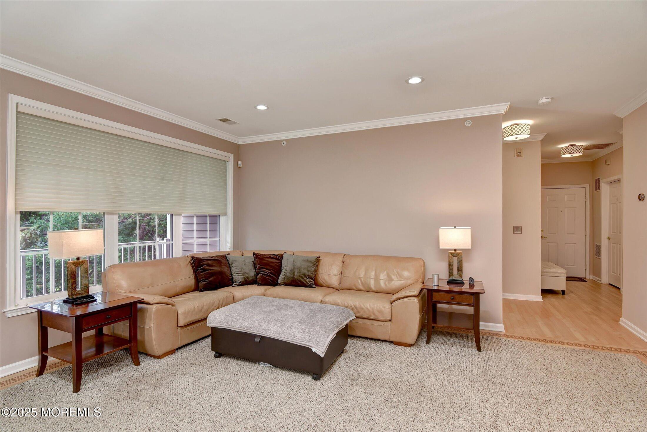 594 St Andrews Place Manalapan, NJ 07726 - Photo 13 of 35 a living room with furniture and a lamp
