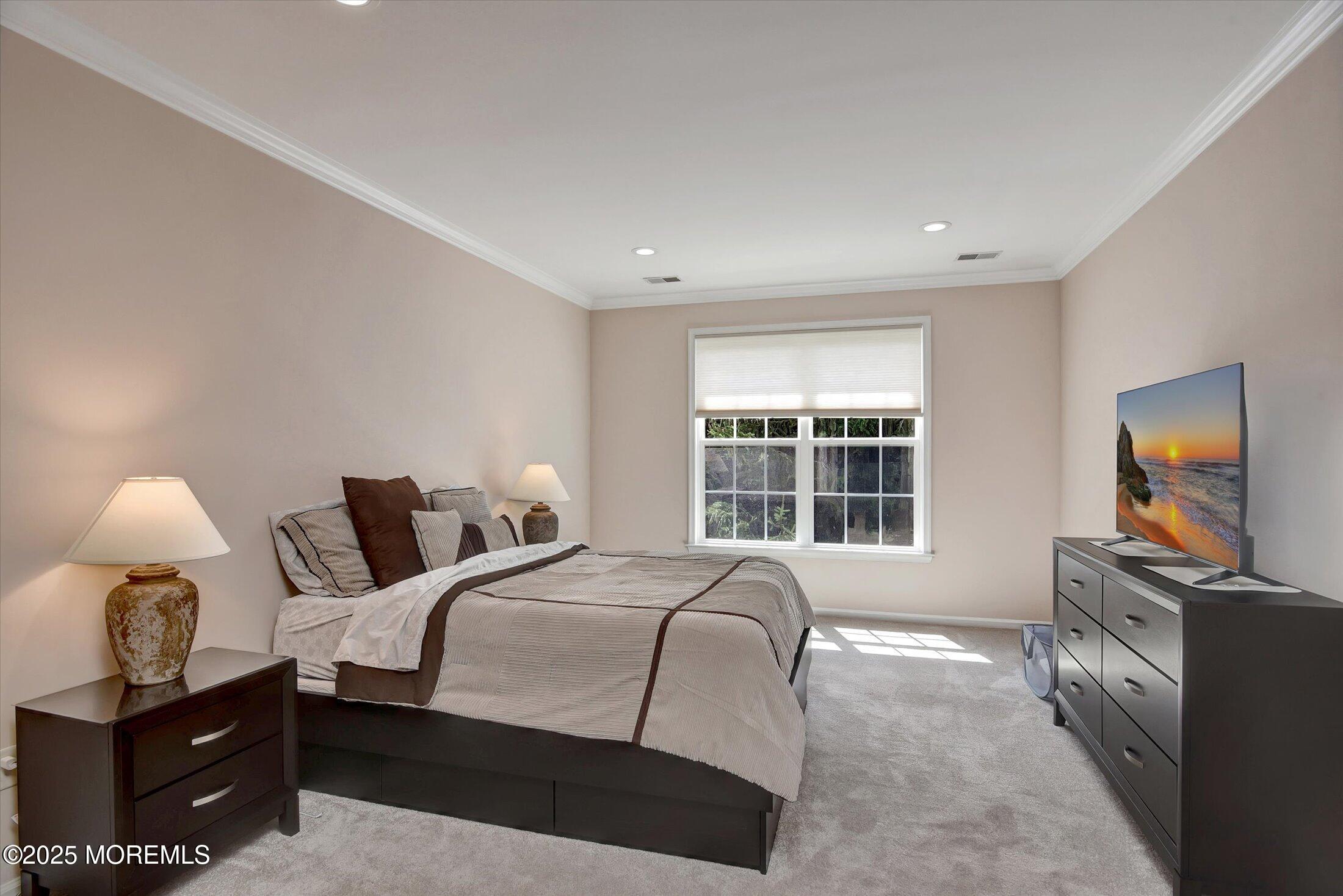 594 St Andrews Place Manalapan, NJ 07726 - Photo 16 of 35 a bedroom with a bed and wooden floor