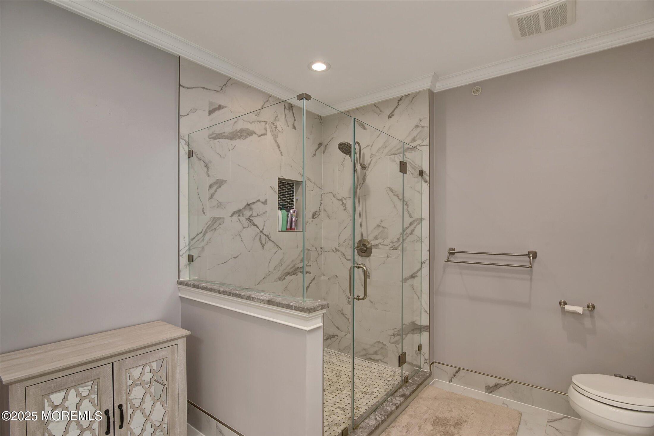 594 St Andrews Place Manalapan, NJ 07726 - Photo 19 of 35 a bathroom with a shower and a toilet