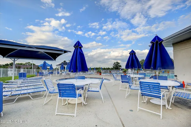 a view of group of chairs and tables in a patio